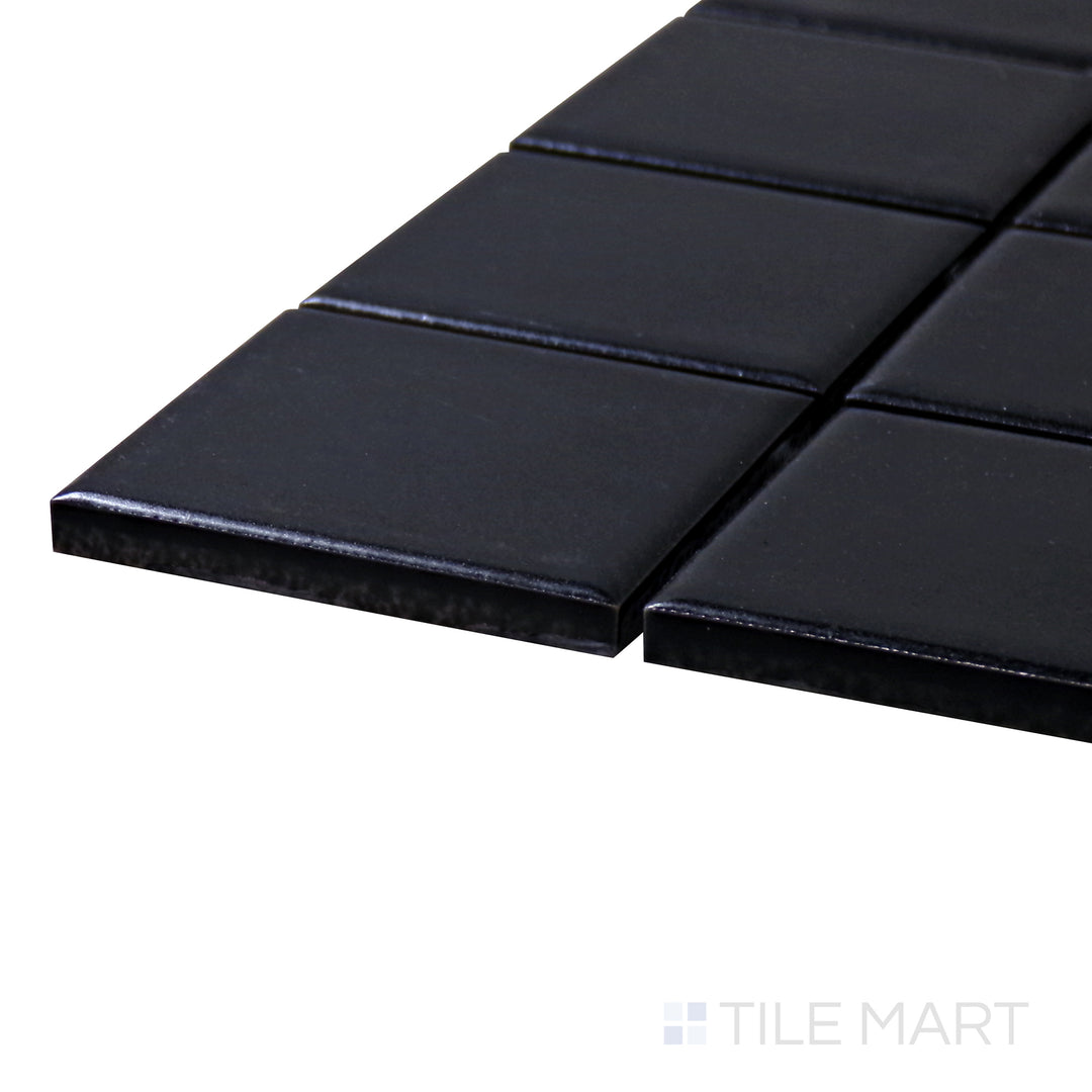 A corner shot of the Porcelain Glazed Mosaics Black 2" Square Matte tile emphasizes its bold black shade and structured square shape, adding depth and elegance to any space.