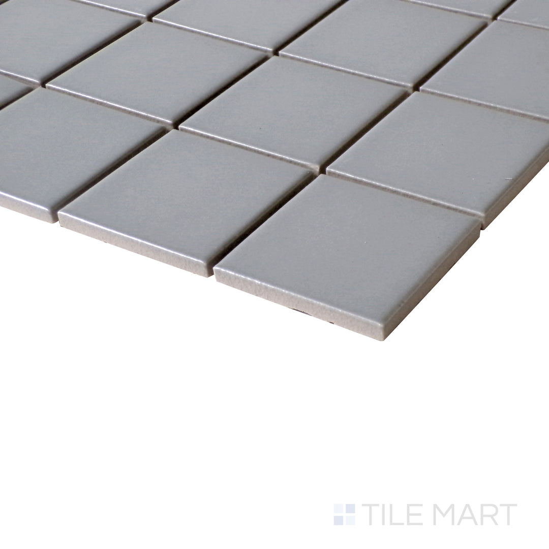 Angled perspective capturing the cool, neutral aesthetic of Porcelain Glazed Gray 2" Square Matte mosaic.