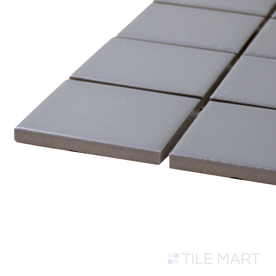 Captured from a corner angle, the Porcelain Glazed Mosaics Gray 2" Square Matte tile presents its refined gray tone and sleek matte surface, perfect for contemporary designs.