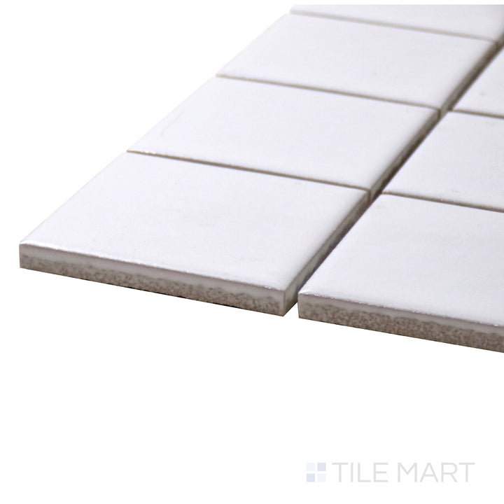 A corner perspective of the Porcelain Glazed Mosaics White 2" Square Matte tile showcases its crisp white color and geometric precision, creating a clean and sophisticated ambiance.