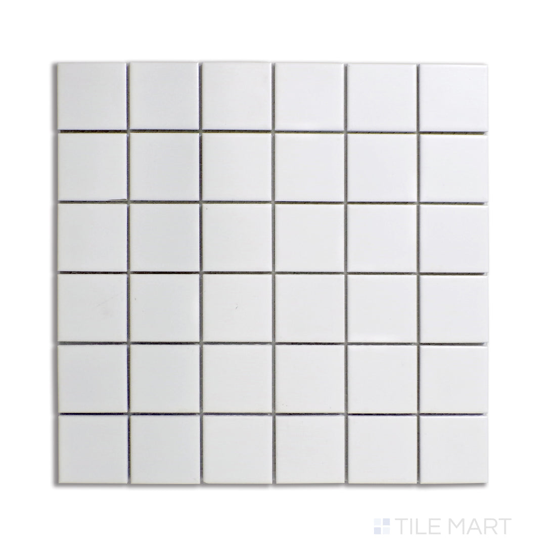 Flat-lay of 2-inch square white matte porcelain mosaic tiles, offering a timeless and neutral design.