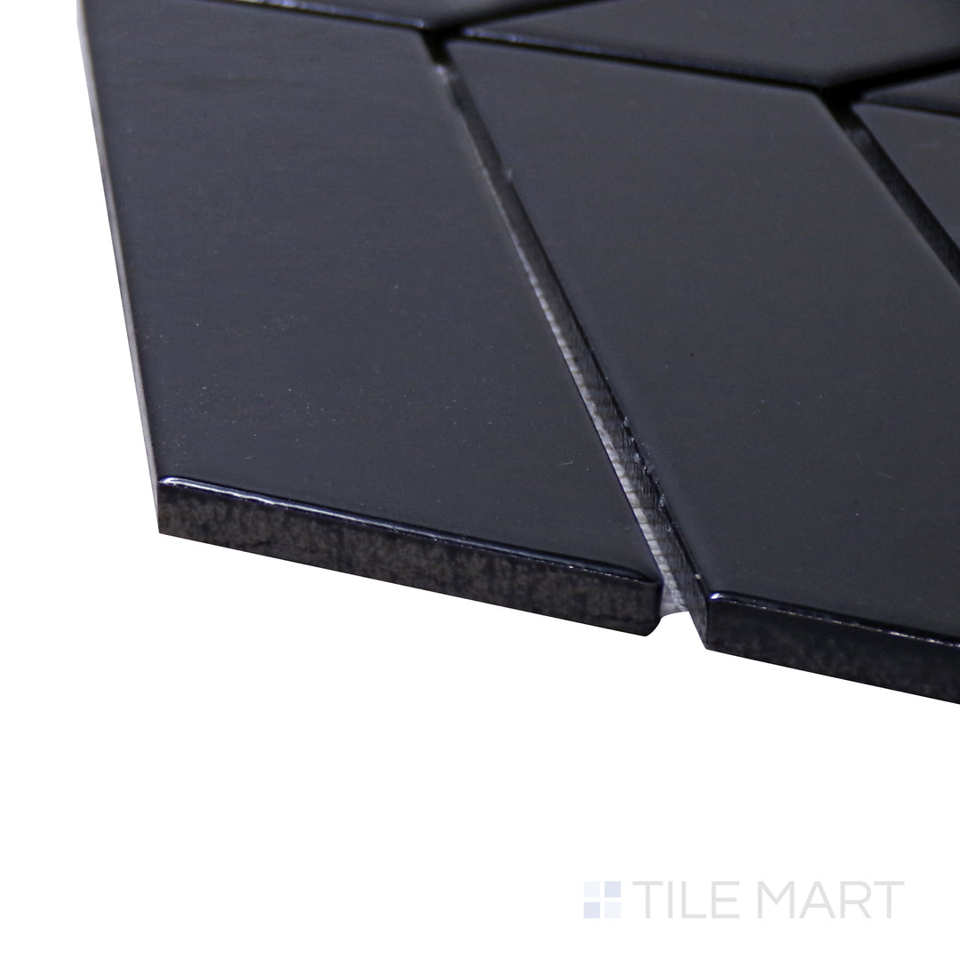 A corner shot of the Shapes Black Chevron Glossy Porcelain Mosaic tile highlights its bold chevron pattern with a high-gloss finish, perfect for dramatic wall applications.