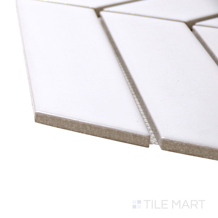 Captured from a corner angle, the Shapes White Chevron Glossy Porcelain Mosaic tile showcases its crisp white tones and glossy sheen, creating a modern and sleek aesthetic.