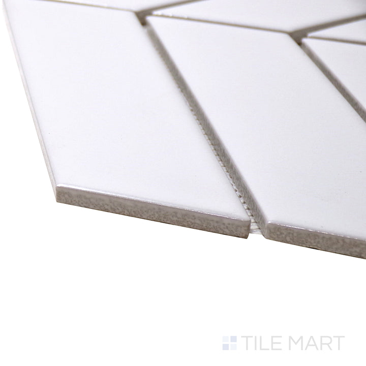 A corner shot of the Shapes White Chevron Matte Porcelain Mosaic tile highlights its soft matte finish and elegant chevron design, blending sophistication with subtle texture.