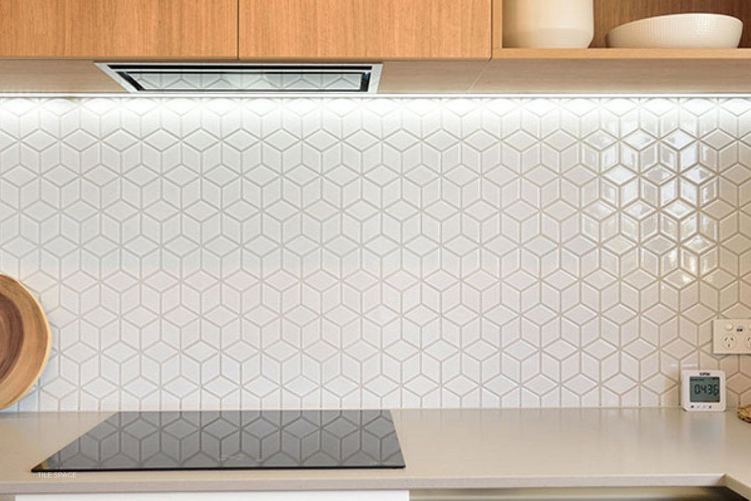 A contemporary room scene displaying Shapes White Cube Glossy Porcelain Mosaic, bringing a geometric and three-dimensional effect to the design.