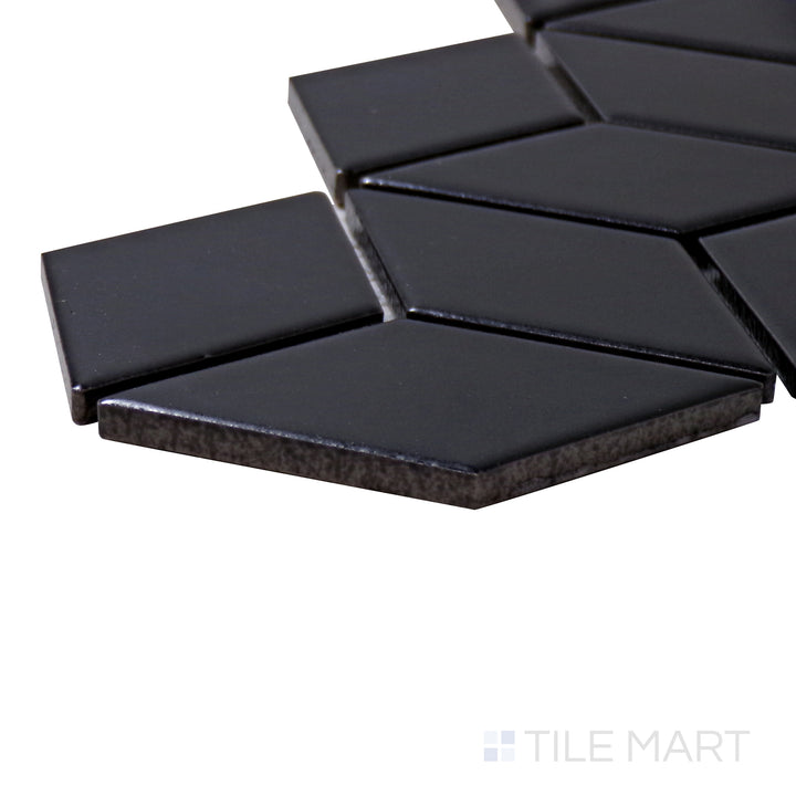 Captured from a corner angle, the Shapes Black Cube Matte Porcelain Mosaic tile showcases its textured matte surface and three-dimensional geometric style.