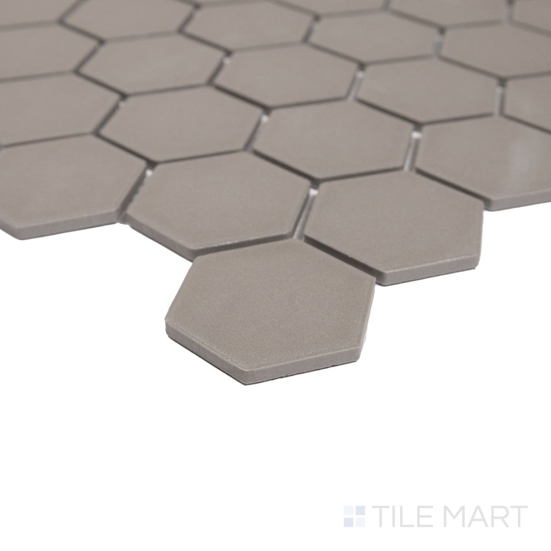 A side view showcasing the smooth, matte texture and geometric charm of Solids Gray 2" Hexagon Porcelain Mosaic.