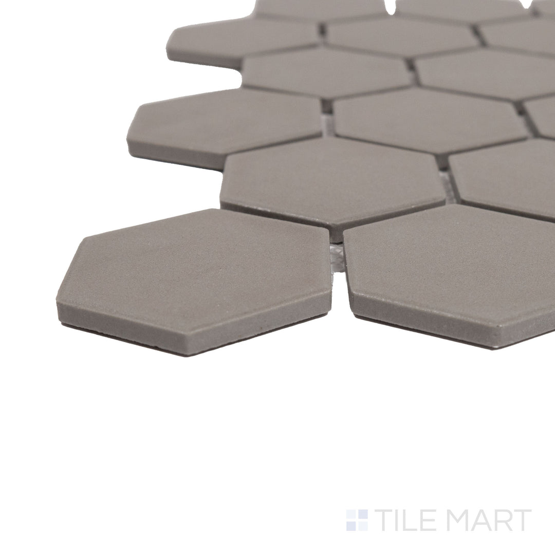 Captured from a corner angle, the Solids Gray 2" Hexagon Matte Porcelain Mosaic tile showcases its neutral gray hue and matte surface, creating a balanced and modern feel.
