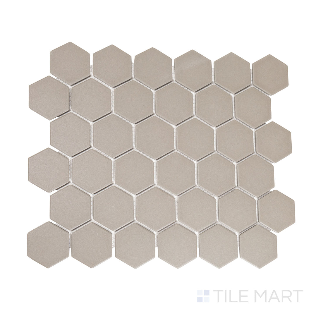 Flat-lay image of gray 2-inch hexagon matte porcelain mosaic tiles, featuring a neutral tone that adds subtle depth to contemporary interiors.