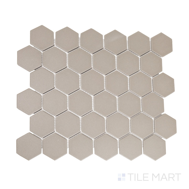 Flat-lay image of gray 2-inch hexagon matte porcelain mosaic tiles, featuring a neutral tone that adds subtle depth to contemporary interiors.