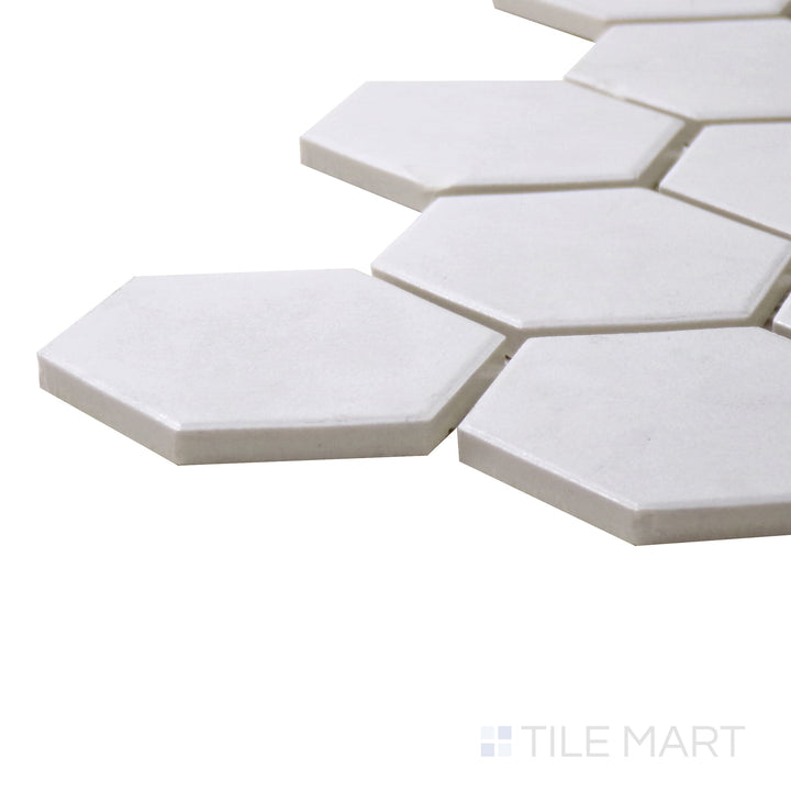 A corner perspective of the Solids White 2" Hexagon Matte Porcelain Mosaic tile highlights its crisp white finish and geometric hexagonal format, perfect for timeless designs.