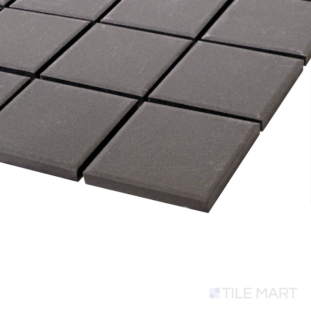 A sleek angle shot highlighting the bold, matte finish and structured layout of Solids Black 2" Square Porcelain Mosaic.