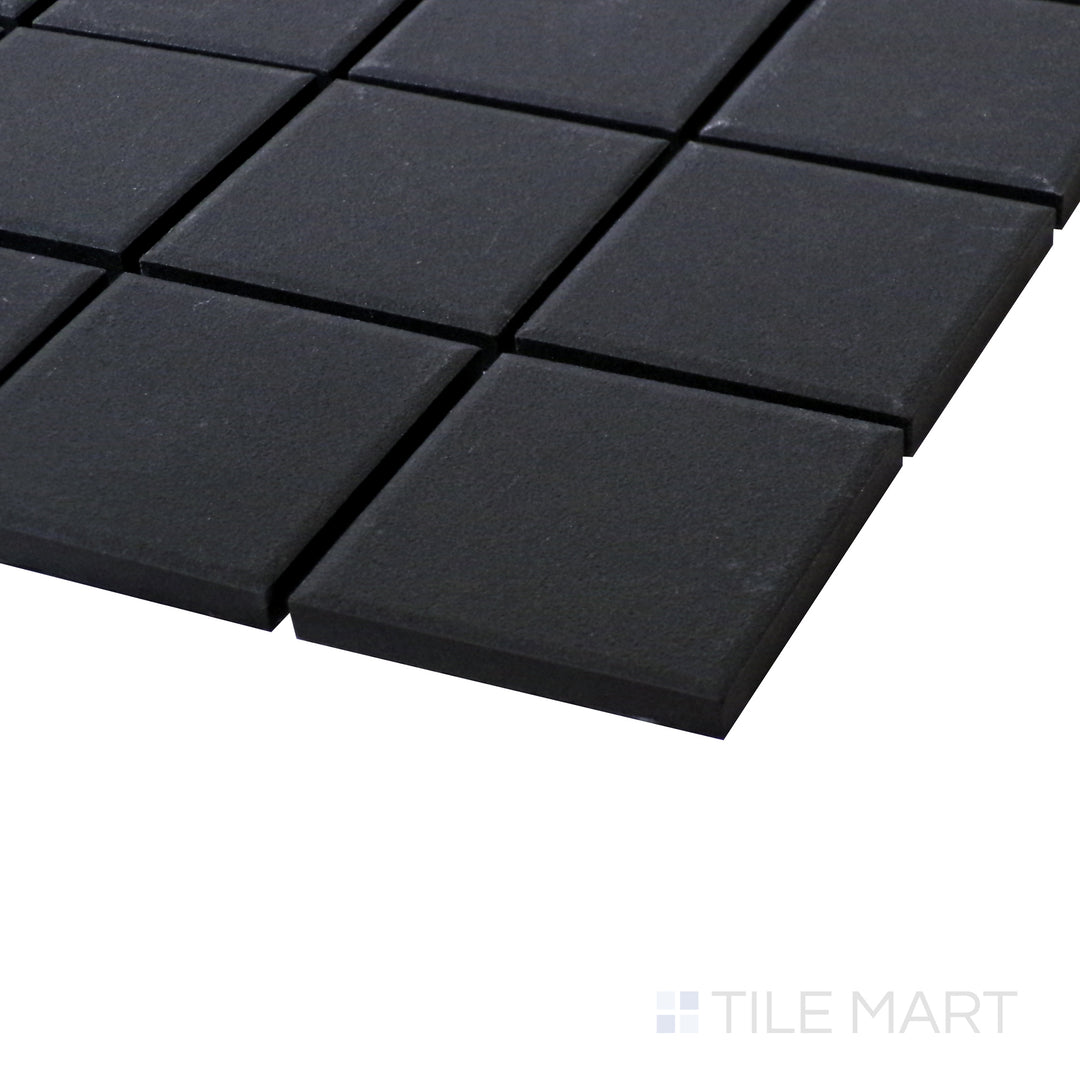 A sleek angle shot highlighting the bold, matte finish and structured layout of Solids Black 2" Square Porcelain Mosaic.
