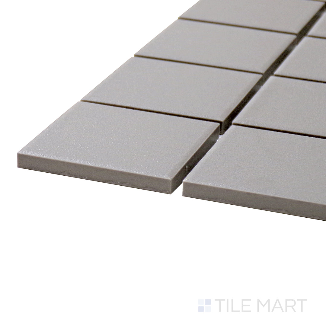 Captured from a corner angle, the Solids Gray 2" Square Matte Porcelain Mosaic tile presents its neutral tone and clean, structured layout for modern aesthetics.