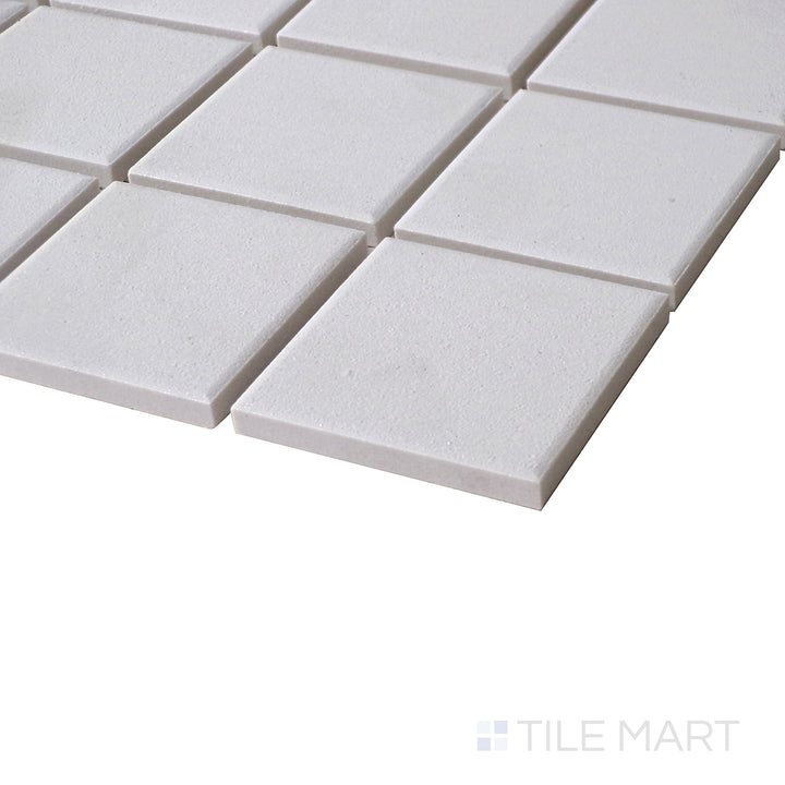 A refined side shot emphasizing the bright, matte finish and modern square pattern of Solids White 2" Square Porcelain Mosaic.