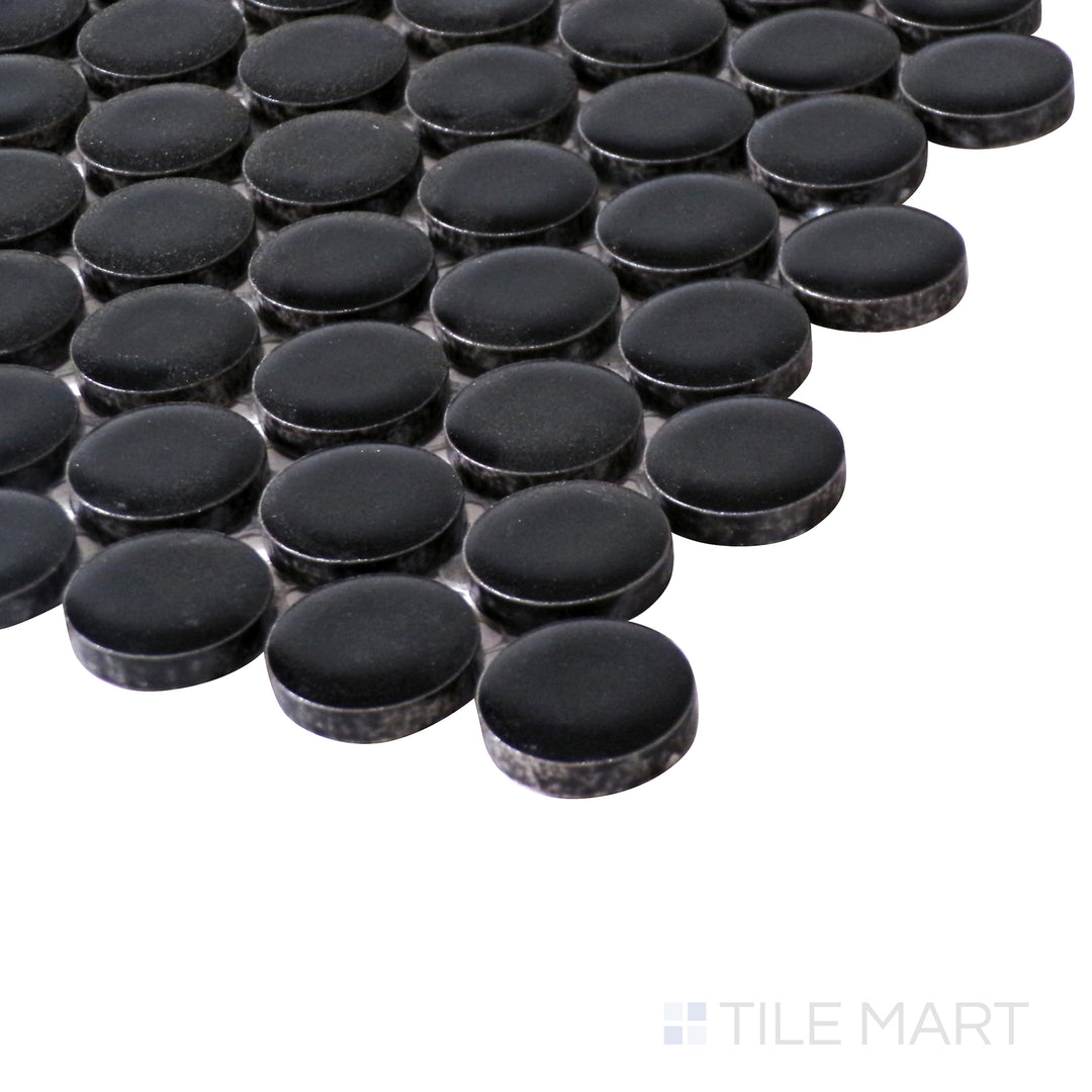 Angled perspective emphasizes the deep black shade and soft matte texture of Pure Black Penny Round Matte Porcelain Mosaic for a modern look.