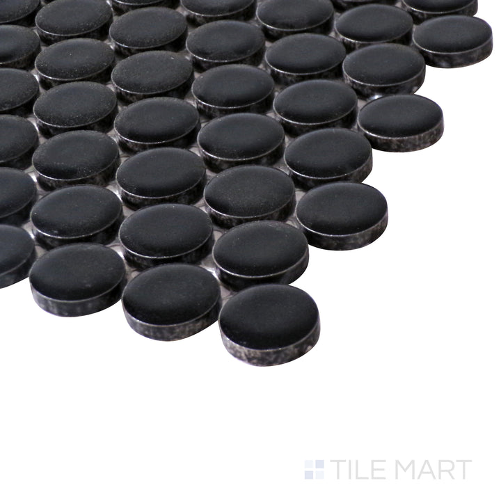 Angled perspective emphasizes the deep black shade and soft matte texture of Pure Black Penny Round Matte Porcelain Mosaic for a modern look.