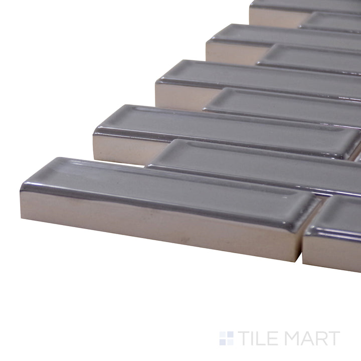 A corner shot of the Roxy Hematite Brick Glossy Porcelain Mosaic showcases its rich hematite shade with a sleek glossy texture, delivering depth and modern sophistication.