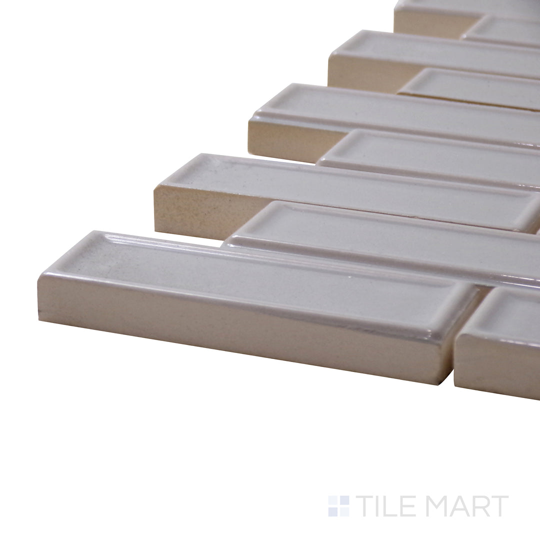 Captured from a corner angle, the Roxy Moonstone Brick Glossy Porcelain Mosaic displays a soft moonstone hue and reflective glossy surface for a stylish and luminous effect.