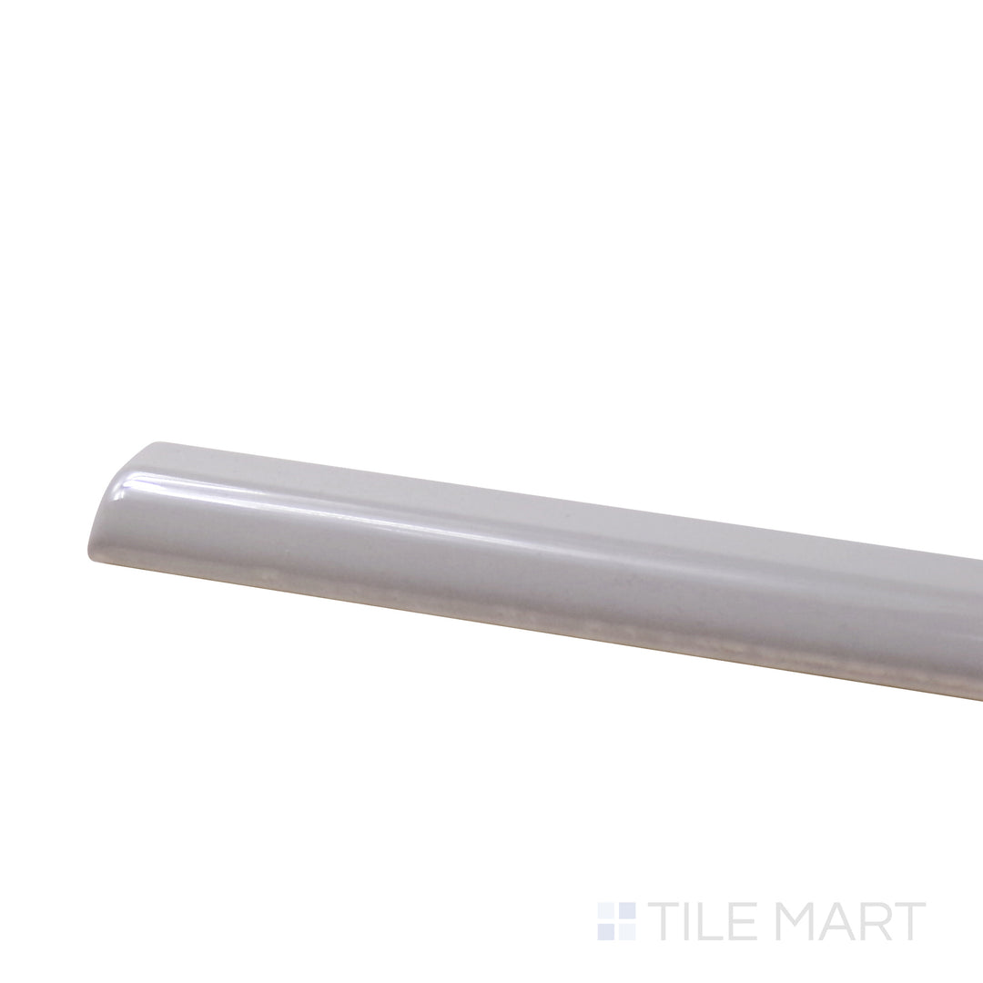 A corner shot of the Roxy Moonstone 0.5X9 Glossy Porcelain Pencil presents a luminous moonstone color with a glossy surface, enhancing design accents with sophistication.