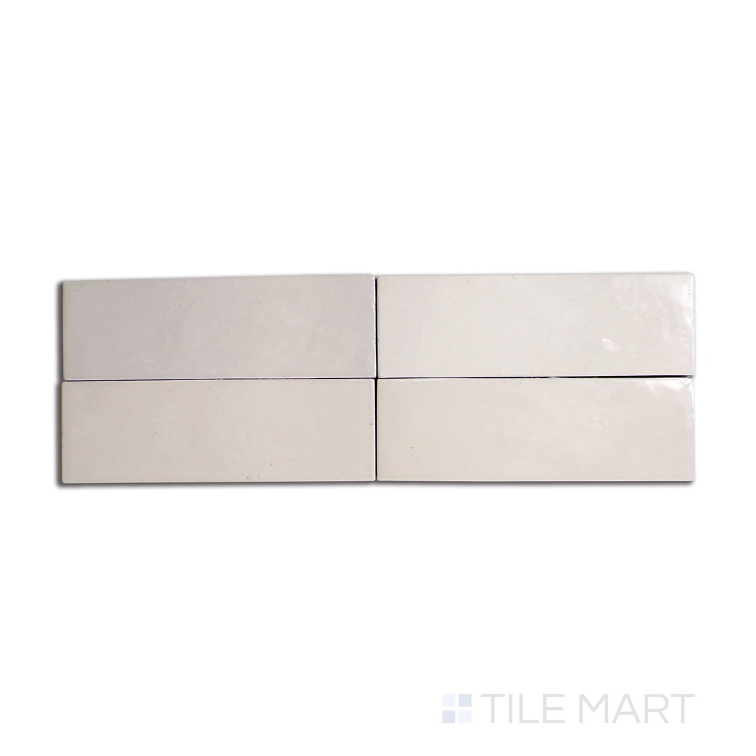 Overhead shot of Safi Nude 2x6 glossy ceramic tile, showcasing a warm, earthy beige tone with a lustrous sheen.