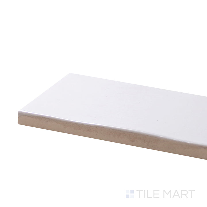 A corner shot of the Safi White 2X6 Glossy Ceramic tile emphasizes its crisp white color and polished glossy surface, ideal for a clean and contemporary look.