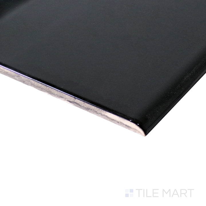 Angled shot emphasizes the bold, deep finish of Sanitary Cove Base Black 6X6 Glossy Porcelain, a sleek accent for modern tiled spaces.