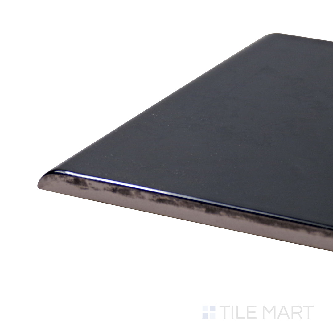 Captured from a corner angle, the Sanitary Cove Base Black 6X6 Glossy Porcelain tile showcases a deep black hue with a high-gloss finish, perfect for bold, modern settings.