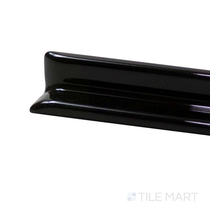 A corner perspective of the Sanitary Cove Base Black 1X6 Glossy Porcelain Inside Corner trim showcases its deep black hue with a glossy texture, enhancing contemporary spaces.