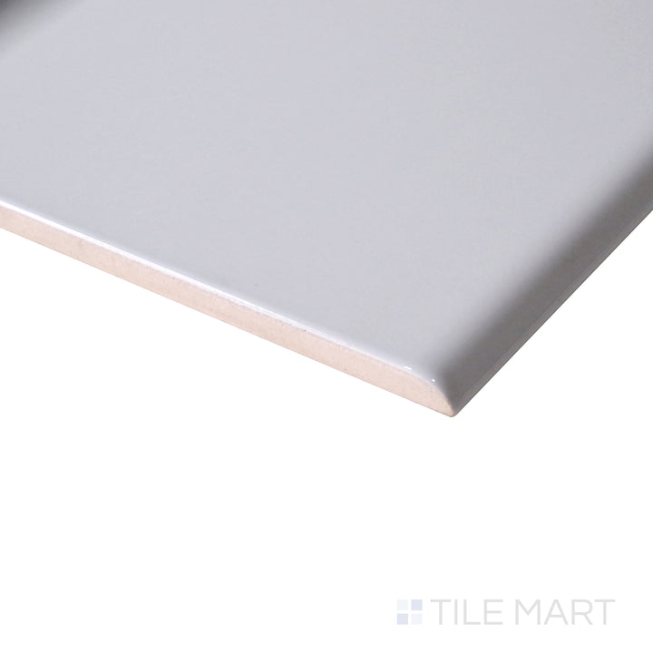 Angled shot enhances the soft, neutral tone of Sanitary Cove Base Gray 6X6 Glossy Porcelain, offering a balanced, modern aesthetic.