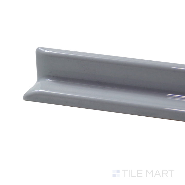 Captured from a corner angle, the Sanitary Cove Base Gray 1X6 Glossy Porcelain Inside Corner trim features a neutral grey color and high-gloss finish, blending seamlessly with various styles.