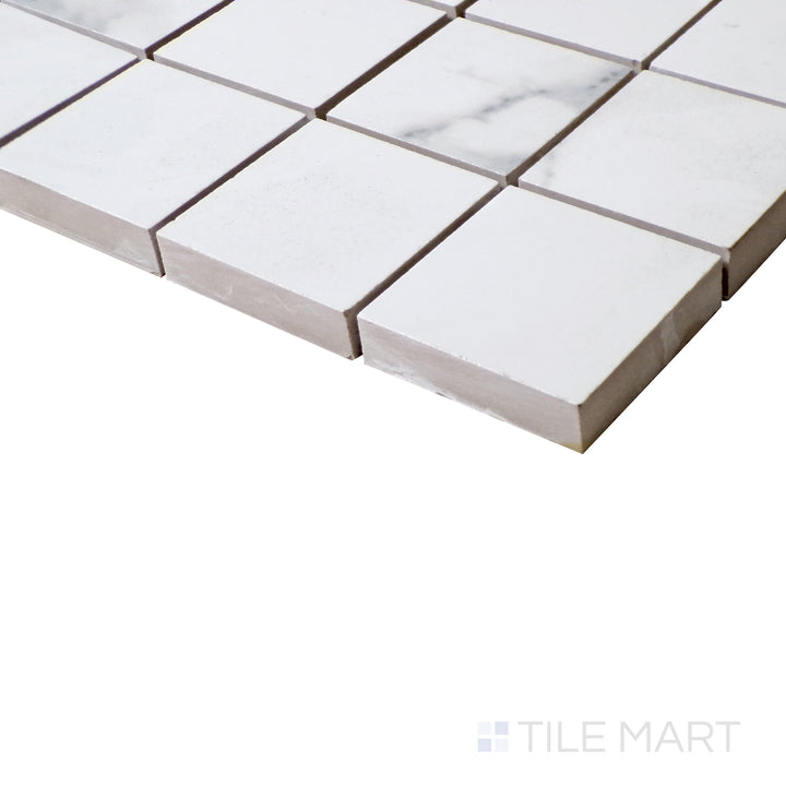 Side shot emphasizes the glossy sheen of Select White Carrara White 2" Square Polished Porcelain Mosaic, perfect for accent walls and luxe finishes.