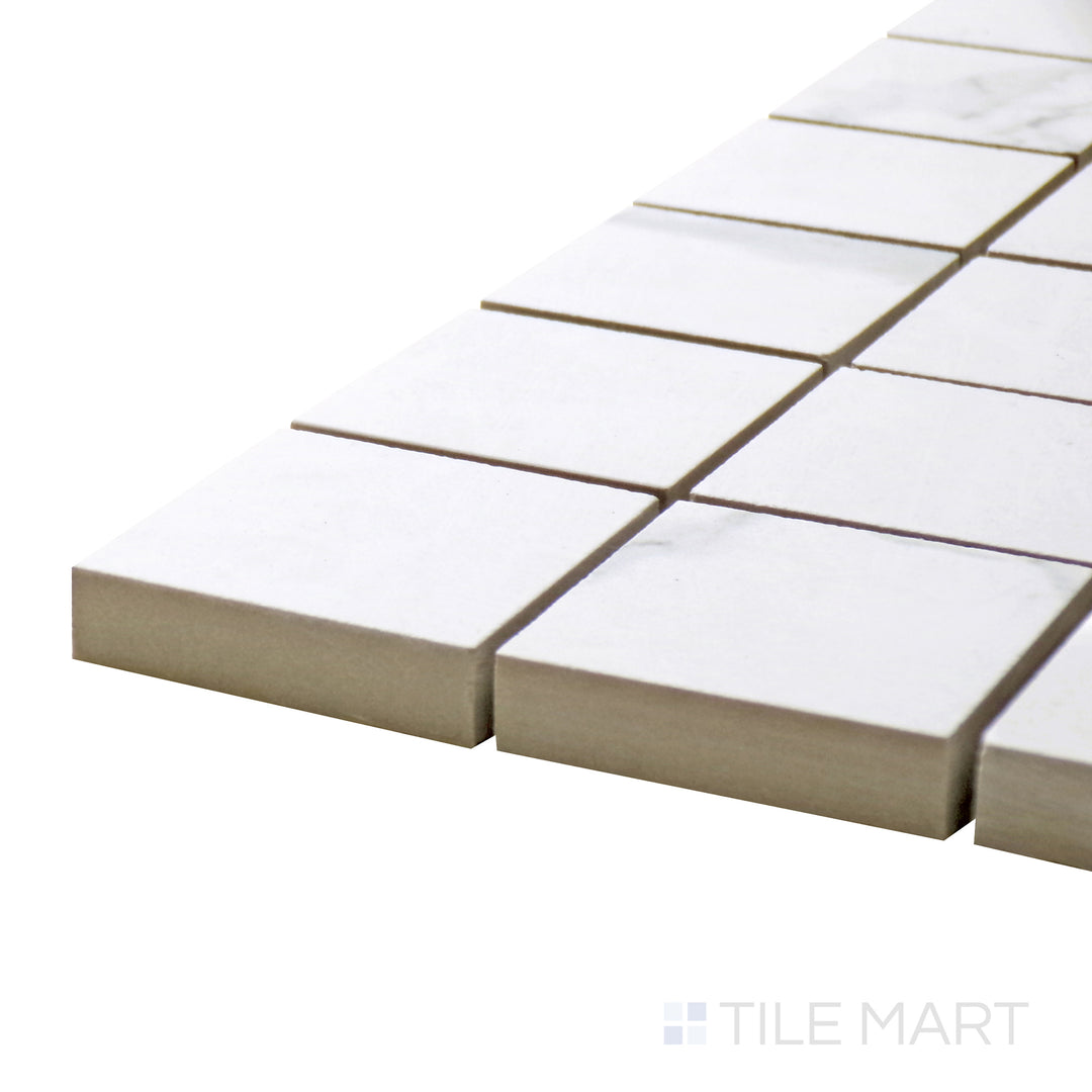 Corner perspective of Select White Carrara White 2" Square Polished Porcelain Mosaic, showcasing its glossy tiles arranged in a precise pattern for a high-end finish.