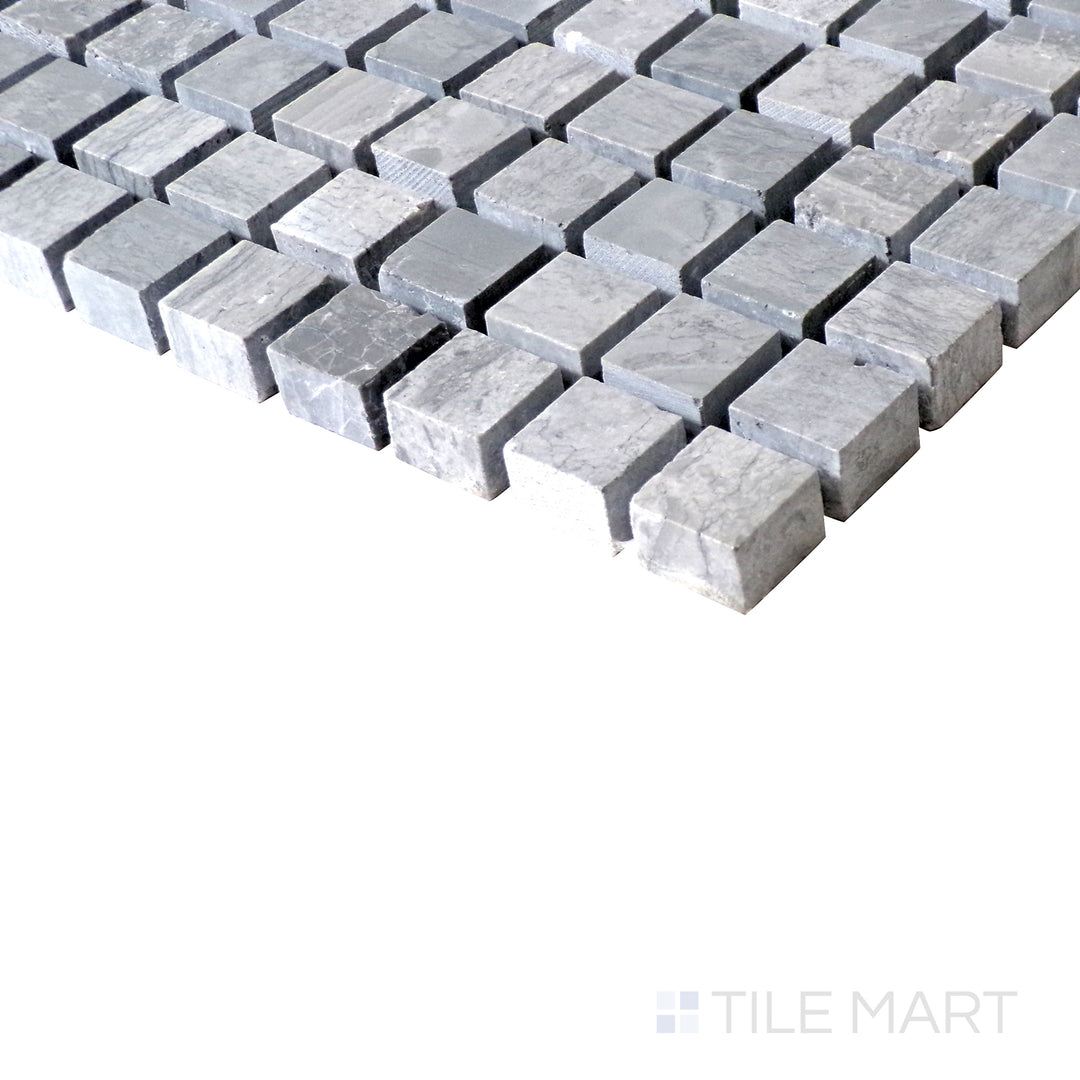 Slanted shot of Sto-Re Wooden Blue 5/8" mini square polished marble mosaic, capturing its distinctive wooden-blue hues, smooth polish, and structured square arrangement.  