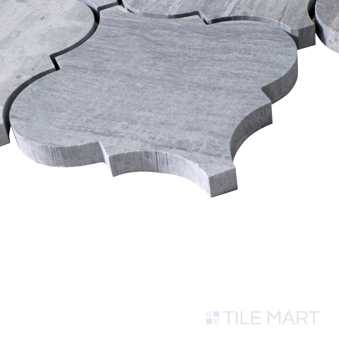 Slanted view of Sto-Re Wooden Blue Arabesque polished marble mosaic, emphasizing its unique wood-like tones, elegant arabesque shapes, and sleek surface.  