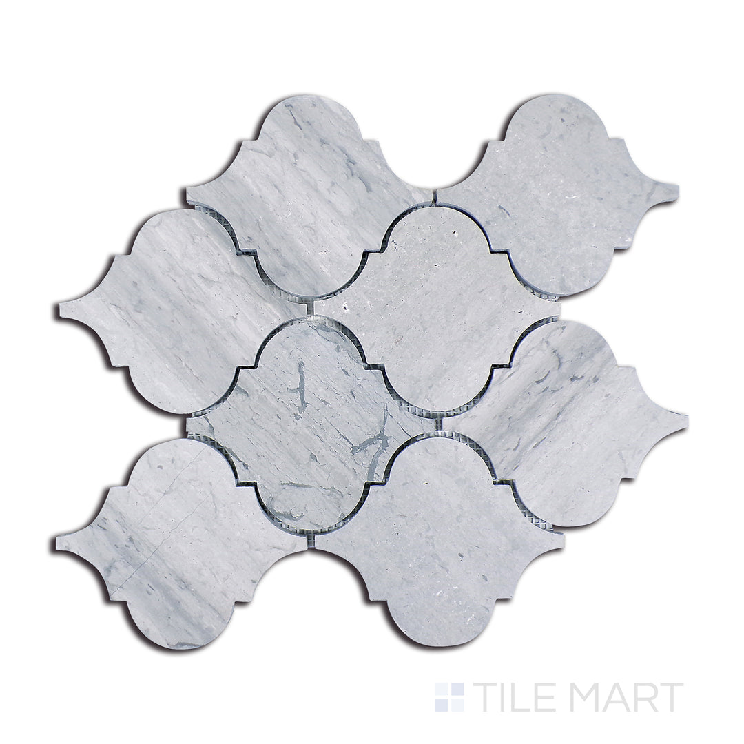 Flat lay of Sto-Re Wooden Blue Arabesque Polished Marble Mosaic, showcasing a bold blue-grey polished marble in a smooth arabesque tile arrangement.