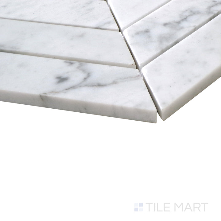 Diagonal view of Sto-Re Carrara Chevron polished marble mosaic, showcasing its elegant white marble with soft gray veining arranged in a striking chevron pattern.  
