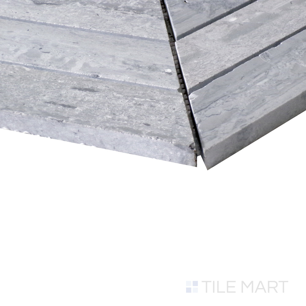 Diagonal shot of Sto-Re Wooden Blue Chevron polished marble mosaic, capturing its unique blend of blue-gray hues, chevron arrangement, and smooth polished texture.  