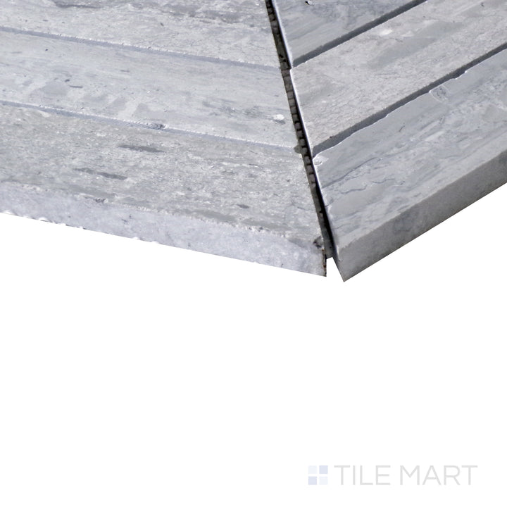 Diagonal shot of Sto-Re Wooden Blue Chevron polished marble mosaic, capturing its unique blend of blue-gray hues, chevron arrangement, and smooth polished texture.  