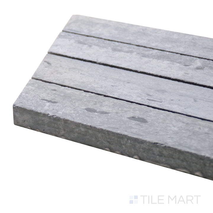 Angled close-up of Sto-Re Wooden Blue Chevron Polished Marble Mosaic, highlighting its unique blue-gray marble hues in a striking chevron arrangement.