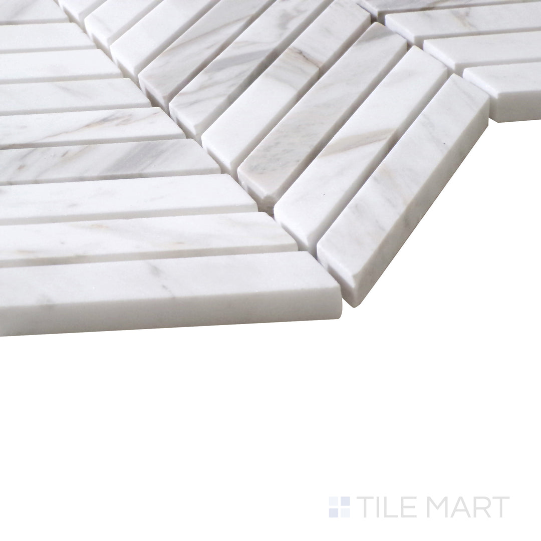 Angled shot of Sto-Re Volakas Chevron polished marble mosaic, highlighting its sophisticated chevron design, subtle veining, and high-gloss finish.  