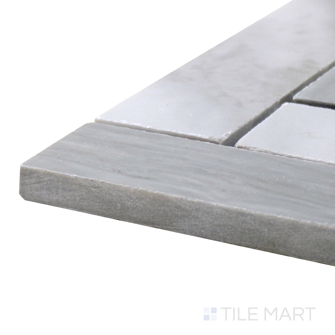 Corner shot of Sto-Re Bardiglio Herringbone Polished Marble Mosaic, highlighting its deep gray tones arranged in a timeless herringbone pattern.