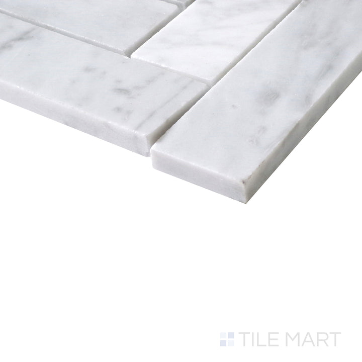 Slanted perspective of Sto-Re Carrara Herringbone polished marble mosaic, featuring a refined white marble base with elegant gray veining in a classic herringbone arrangement.  
