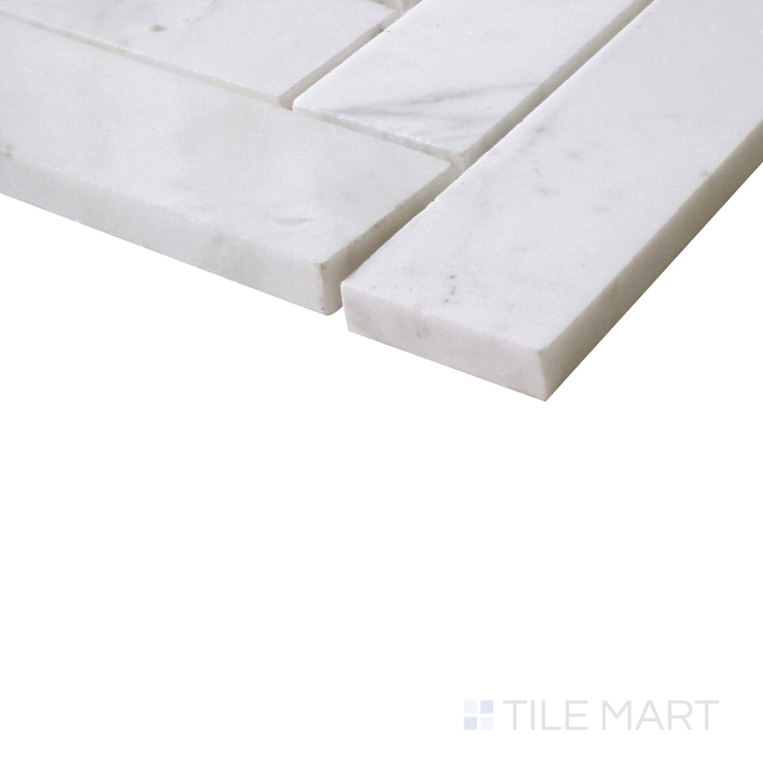 Angled perspective of Sto-Re Volakas Herringbone polished marble mosaic, emphasizing its delicate veining, high-gloss finish, and well-defined herringbone structure.  