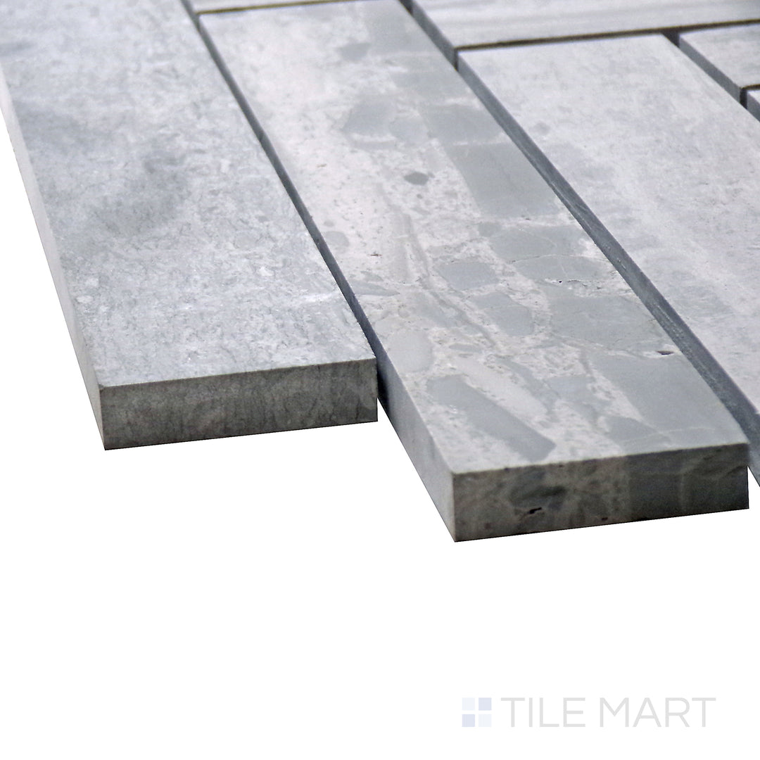 Side perspective of Sto-Re Wooden Blue Herringbone Polished Marble Mosaic, capturing its sophisticated blue-gray hues in a dynamic herringbone pattern.