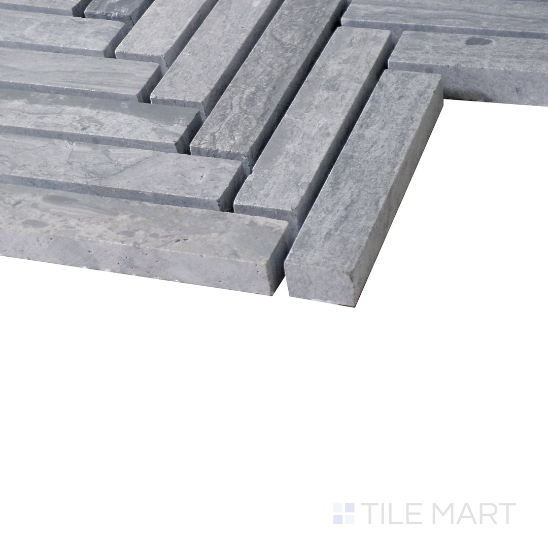 Diagonal view of Sto-Re Wooden Blue Herringbone polished marble mosaic, highlighting its soft blue-gray tones, elegant herringbone layout, and smooth polished texture.  