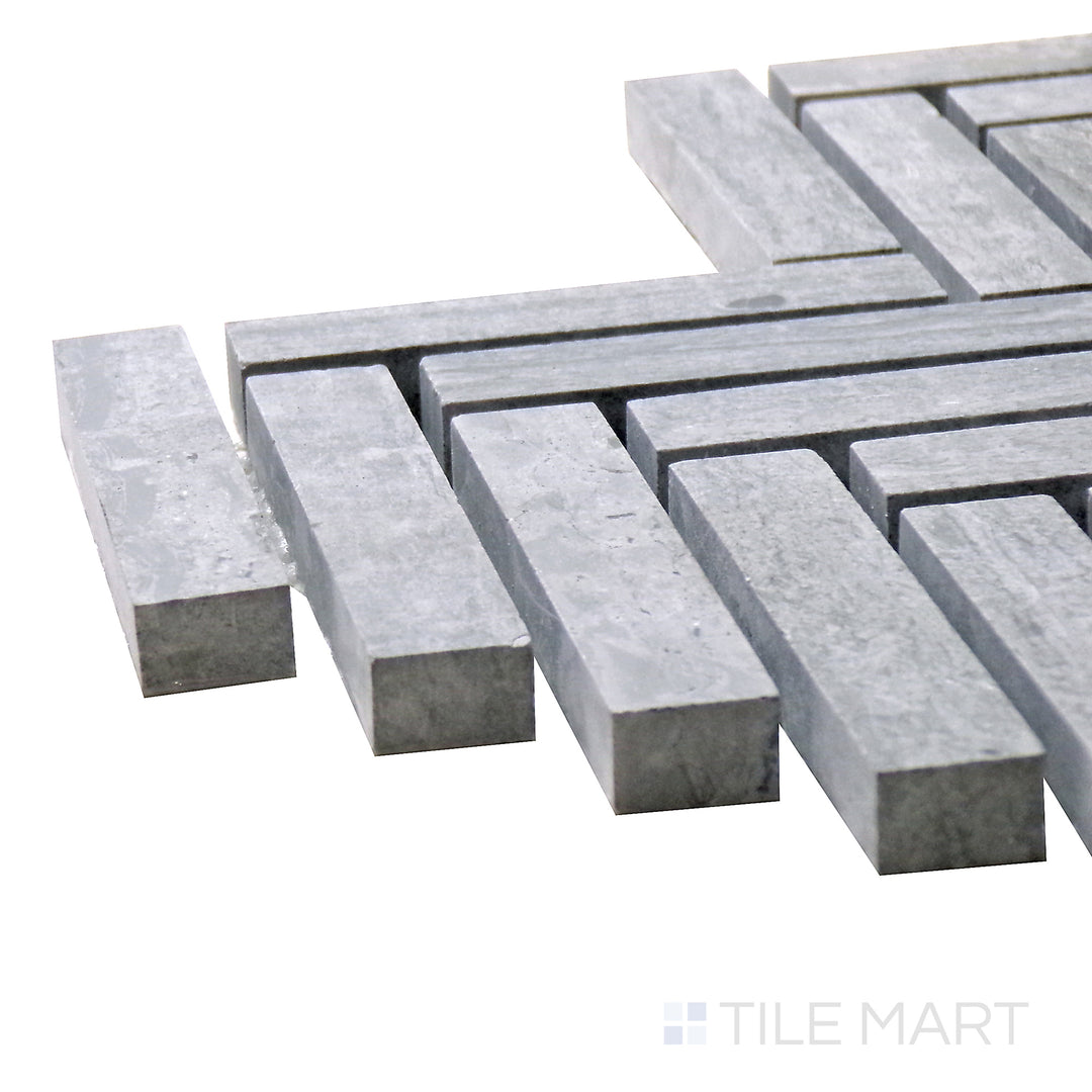 Corner shot of Sto-Re Wooden Blue Herringbone Polished Marble Mosaic, featuring its elegant blue-gray marble tones in a polished herringbone layout.