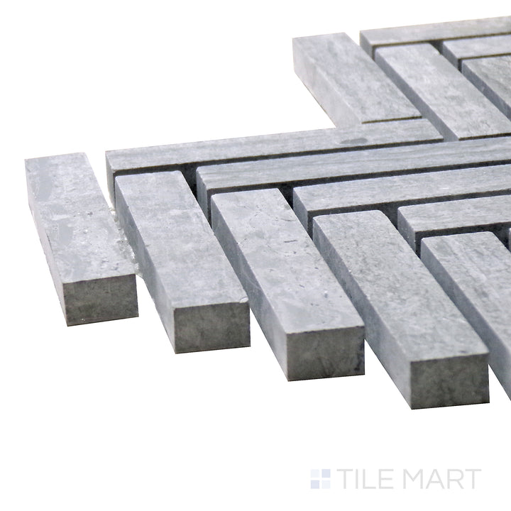 Corner shot of Sto-Re Wooden Blue Herringbone Polished Marble Mosaic, featuring its elegant blue-gray marble tones in a polished herringbone layout.