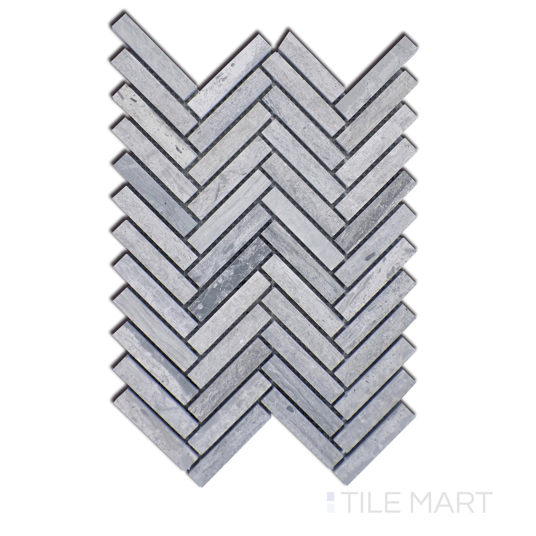 Close-up of Sto-Re Wooden Blue Herringbone Polished Marble Mosaic, highlighting the striking blue-grey hues in an intricate herringbone pattern with a glossy surface.