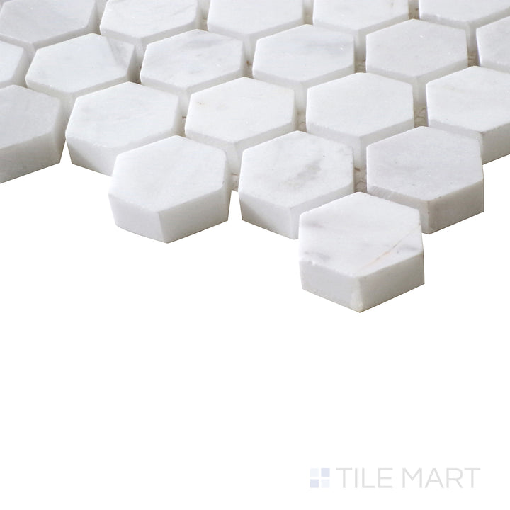 Angled shot of Sto-Re Volakas 1-1/8" Hexagon polished marble mosaic, emphasizing its soft veining, high-gloss finish, and well-defined hexagonal pattern.  